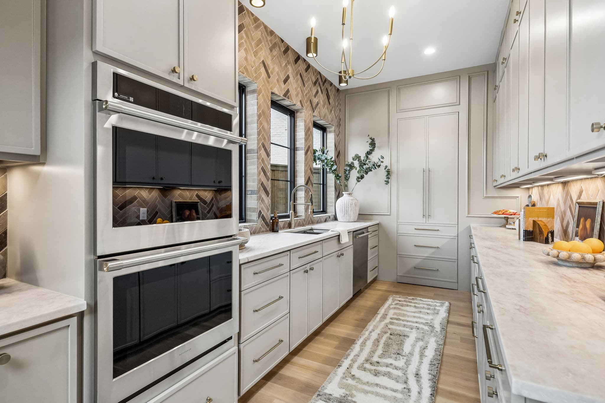 The butler's pantry at 7272 Tangleglen, twin wall ovens set into pale cabinetry beside a run of counter.