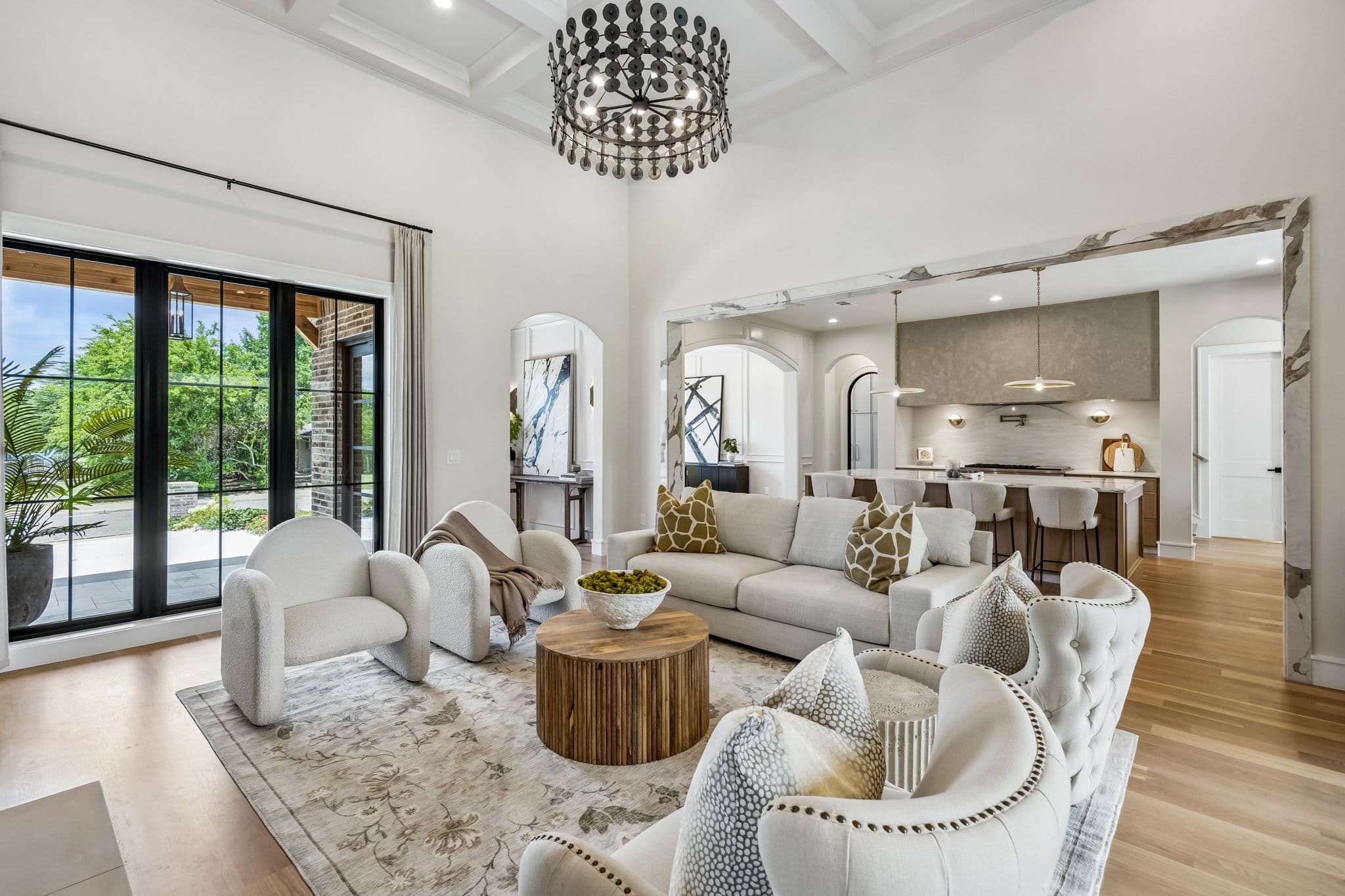 Living room at 7308 Tangleglen, seating gathered under a beamed ceiling beside tall windows.