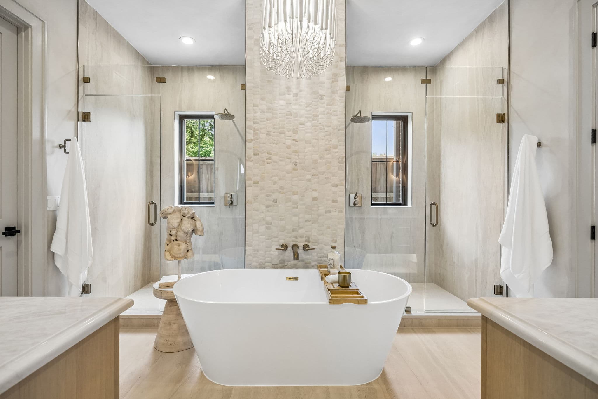 Primary bath at 7308 Tangleglen, freestanding tub centred under a window.