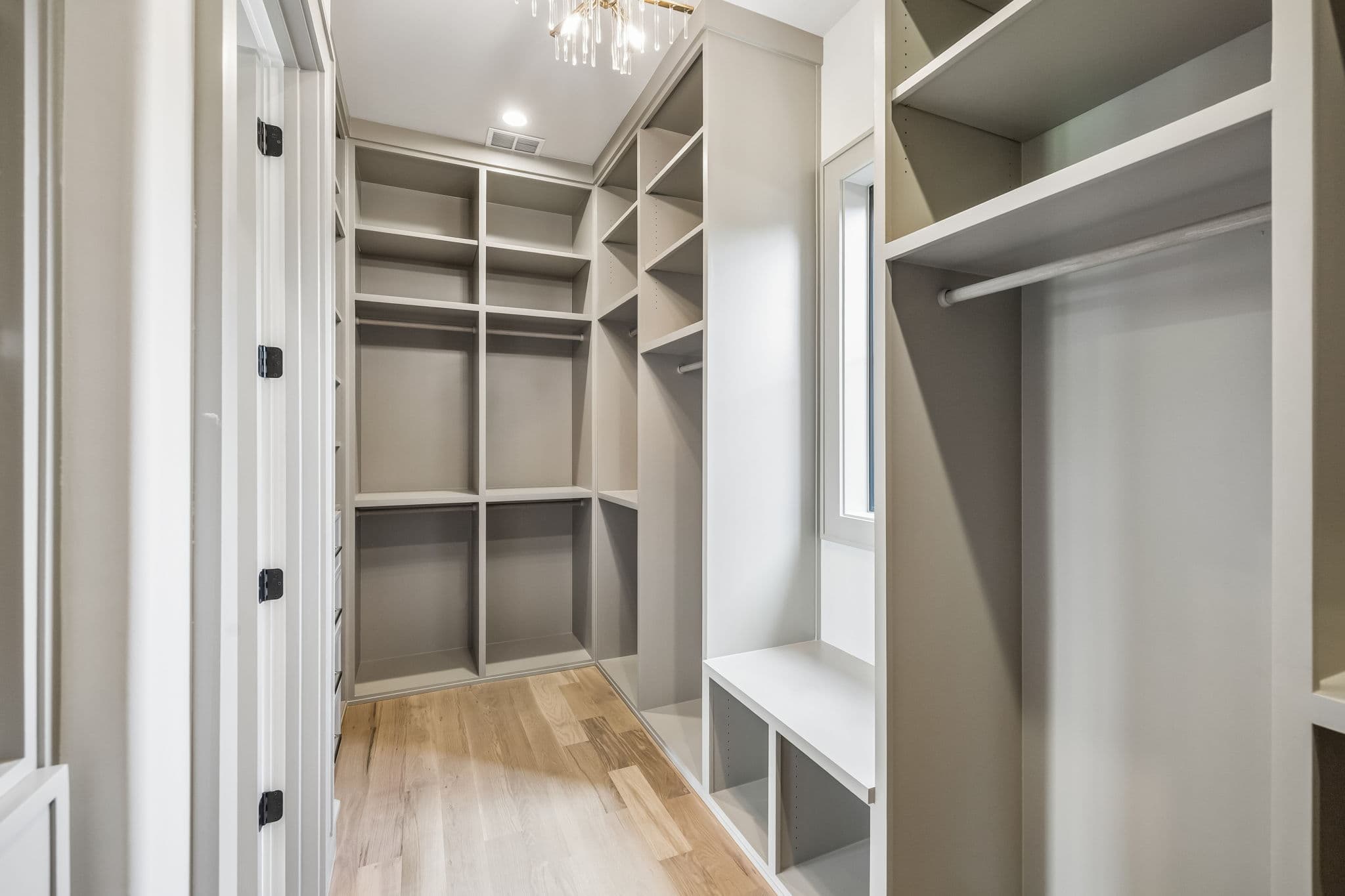 The dressing room at 7308 Tangleglen, built in shelving and hanging rails around a fitted island.