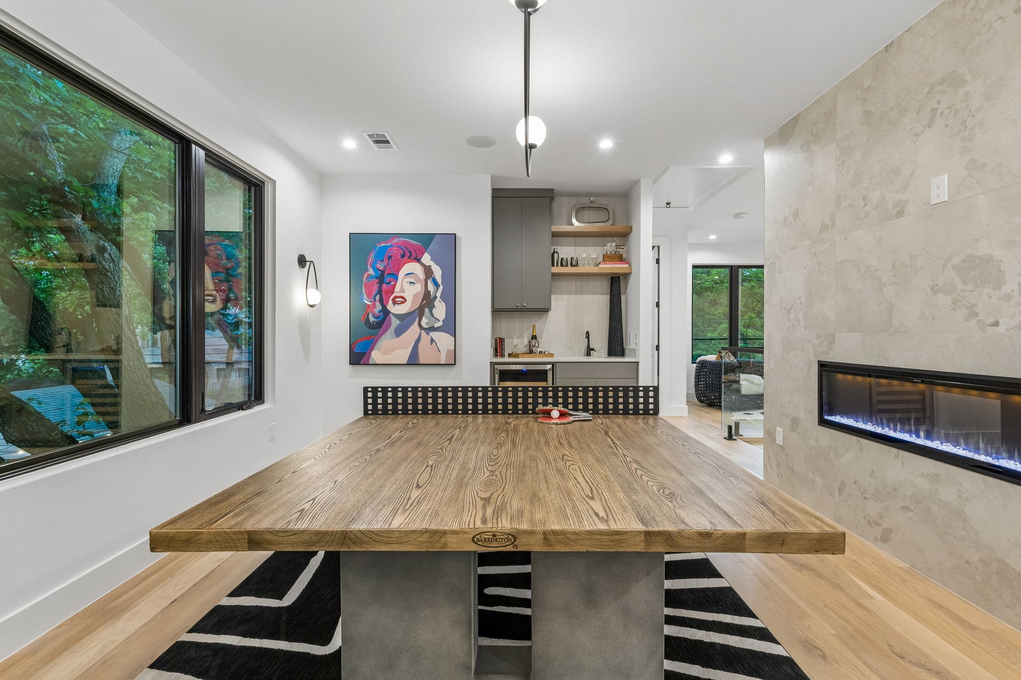 The bar at 7615 Morton, a stone counter under pendants with a fireplace along the wall behind.