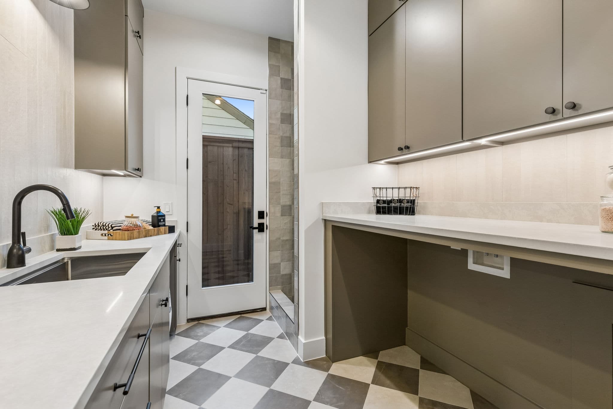 The laundry at 7615 Morton, a checkerboard floor under a run of counter and a sink.