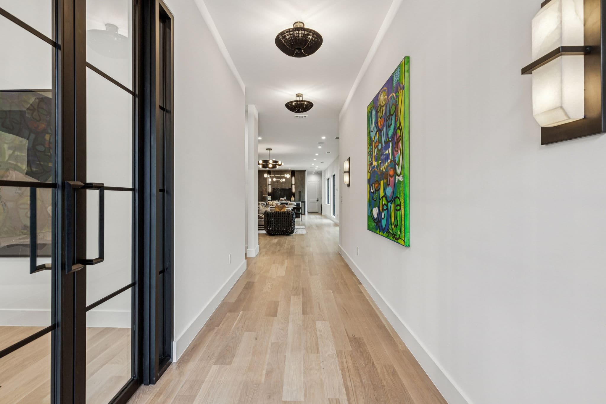 The hall at 7707 Robin Road, oak floors running the length of the house with pictures along one wall.