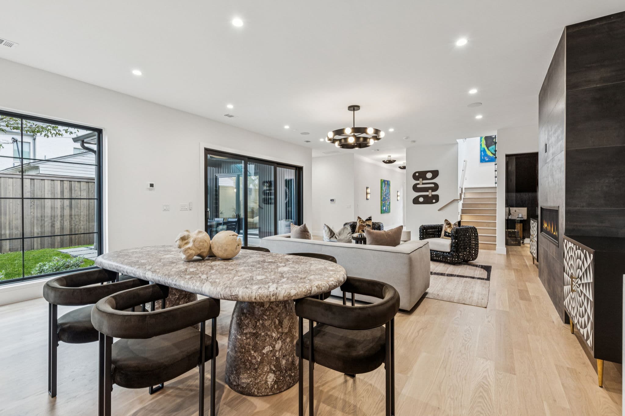 The kitchen at 7707 Robin Road from the dining end, an island between the table and the range wall.