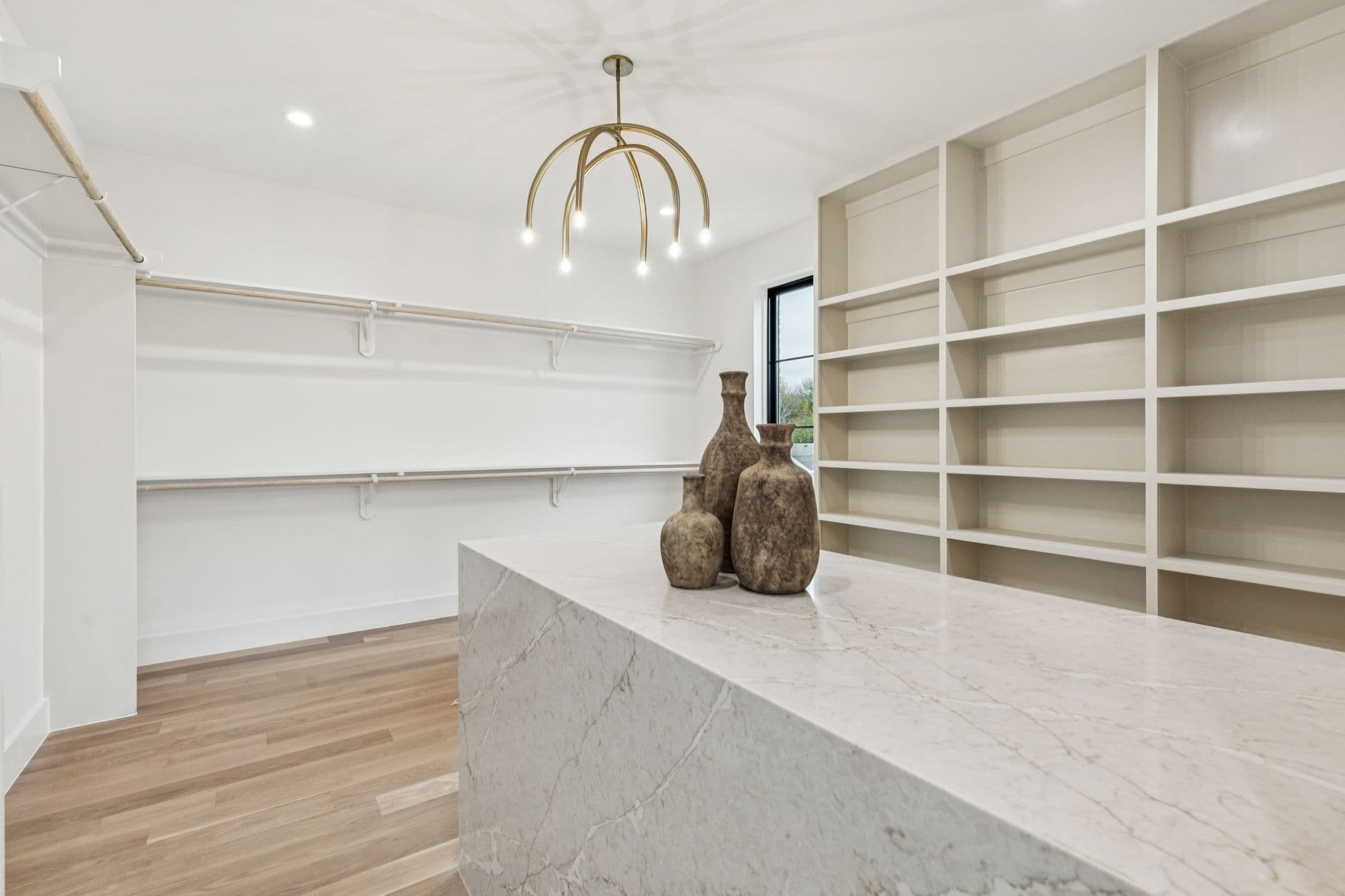 The dressing room at 7707 Robin Road, built in shelving around a fitted island.